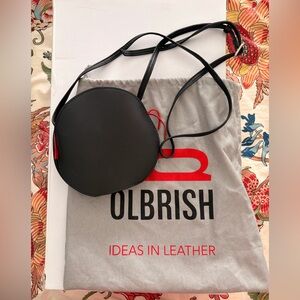 Round Black Crossbody Bag with Red Accent